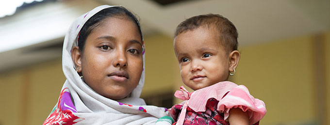 Rahae Na Bagum, 19, holds her 18-month-old baby at Dai Pai Hospital in Rakhine State, in September 2013, before humanitarian staff were evacuated following attacks in March 2014. Photo credit: UNFPA Myanmar