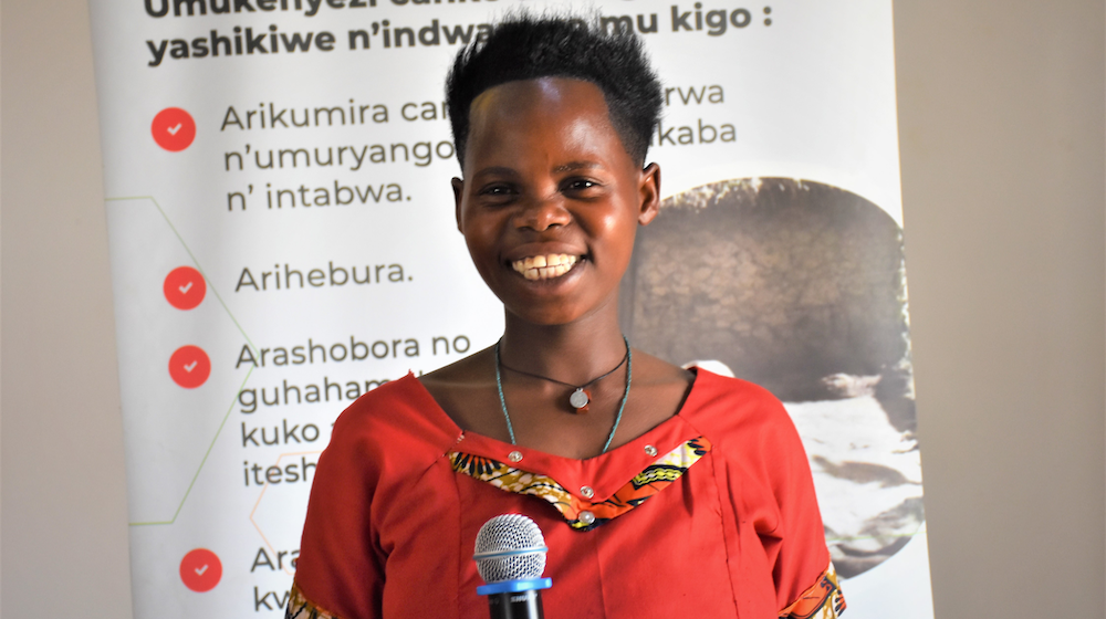 A woman holds a microphone.