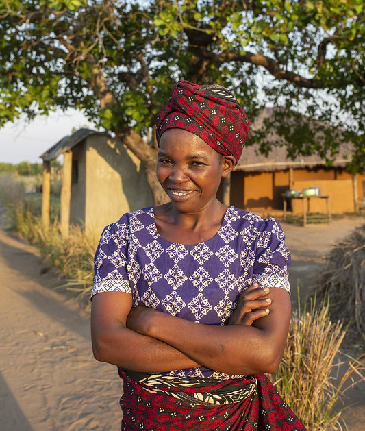 Woman in front of house and tree