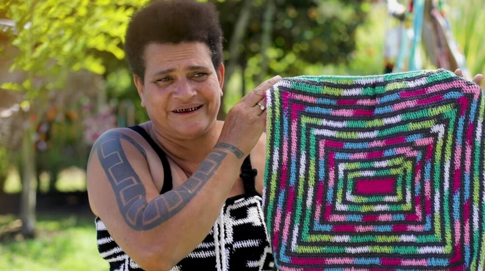 Florence, a weaver, shows a square-shaped bilum design.