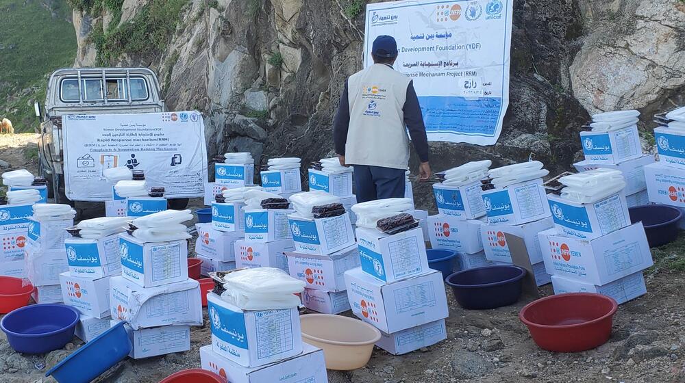 A UNFPA worker prepares packages of essential items to be distributed to individuals at the shelter