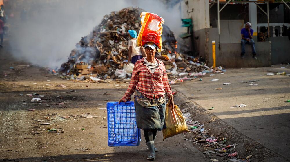 A woman carries goods.