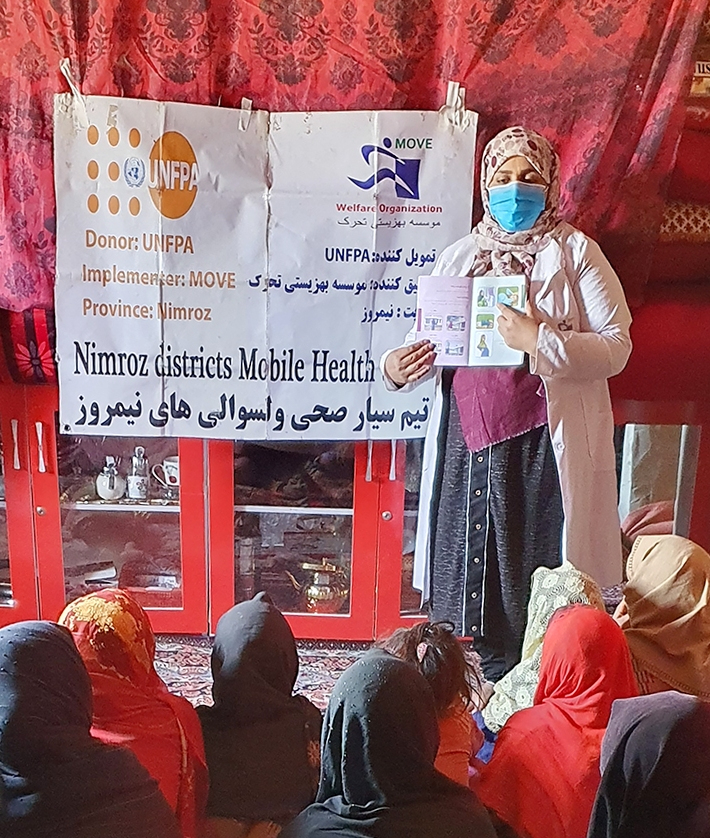 A woman gives a presentation to a group.