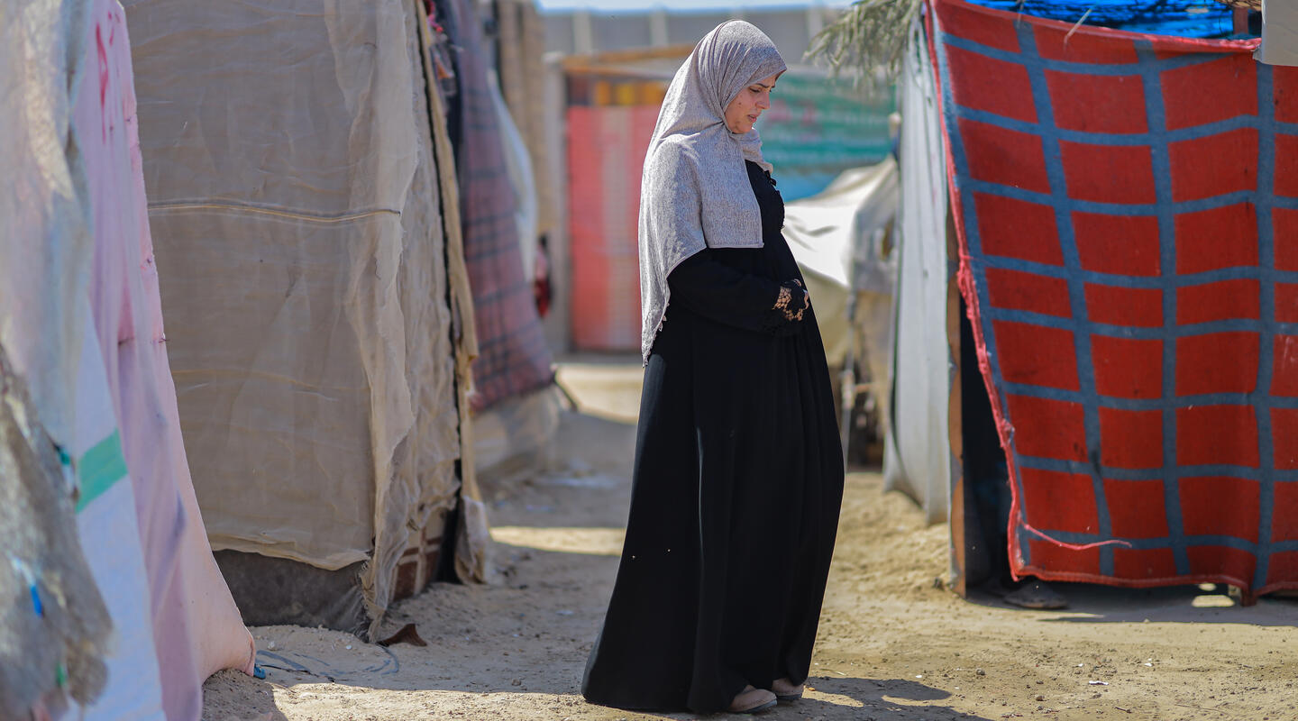 Forced from home: A pregnant woman lives in a tent at the Deir al-Balah camp.