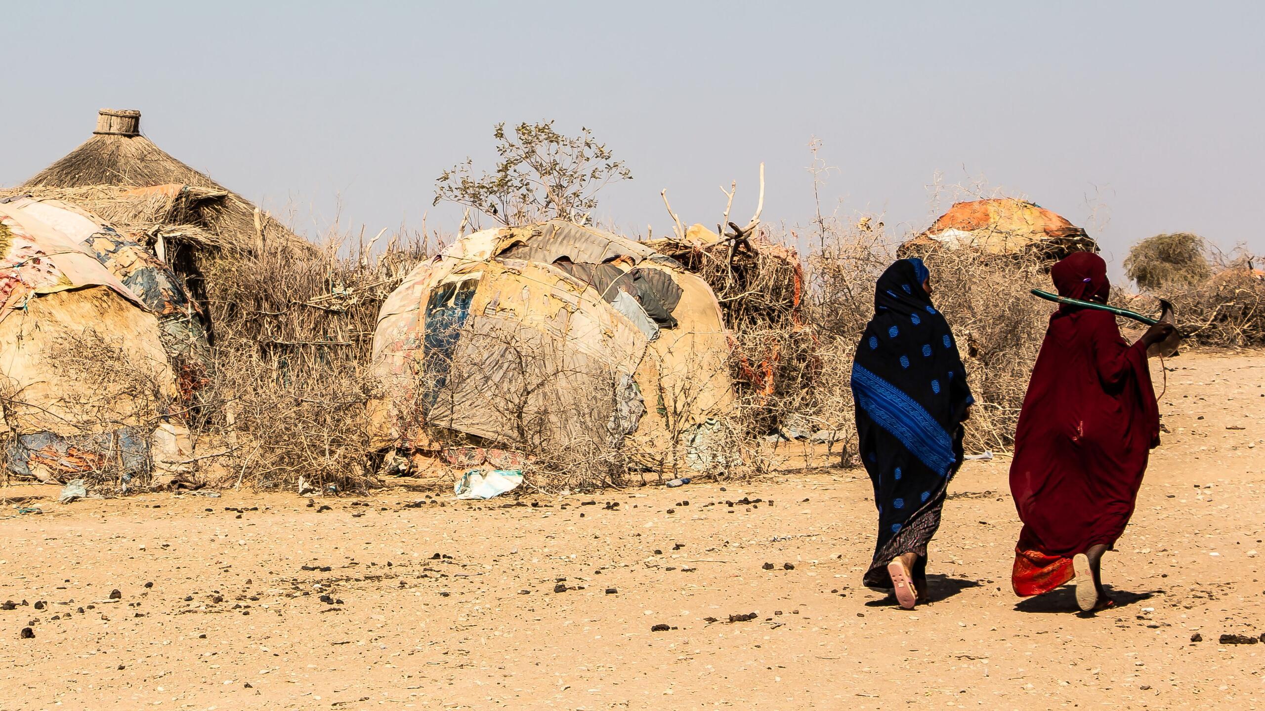 Dos mujeres caminan en un desierto.