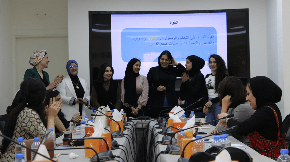 A group of women participating in a conference room.