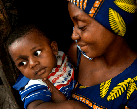 A woman smiles down at her son.