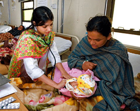 A midwife listens to a baby's heartbeat.