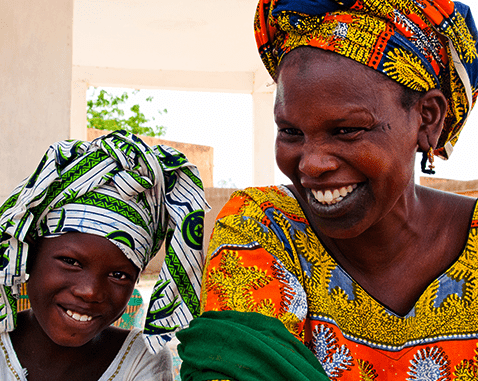 A mother and daughter laughing.