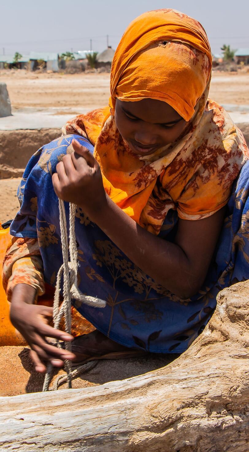 A young woman performs a task.