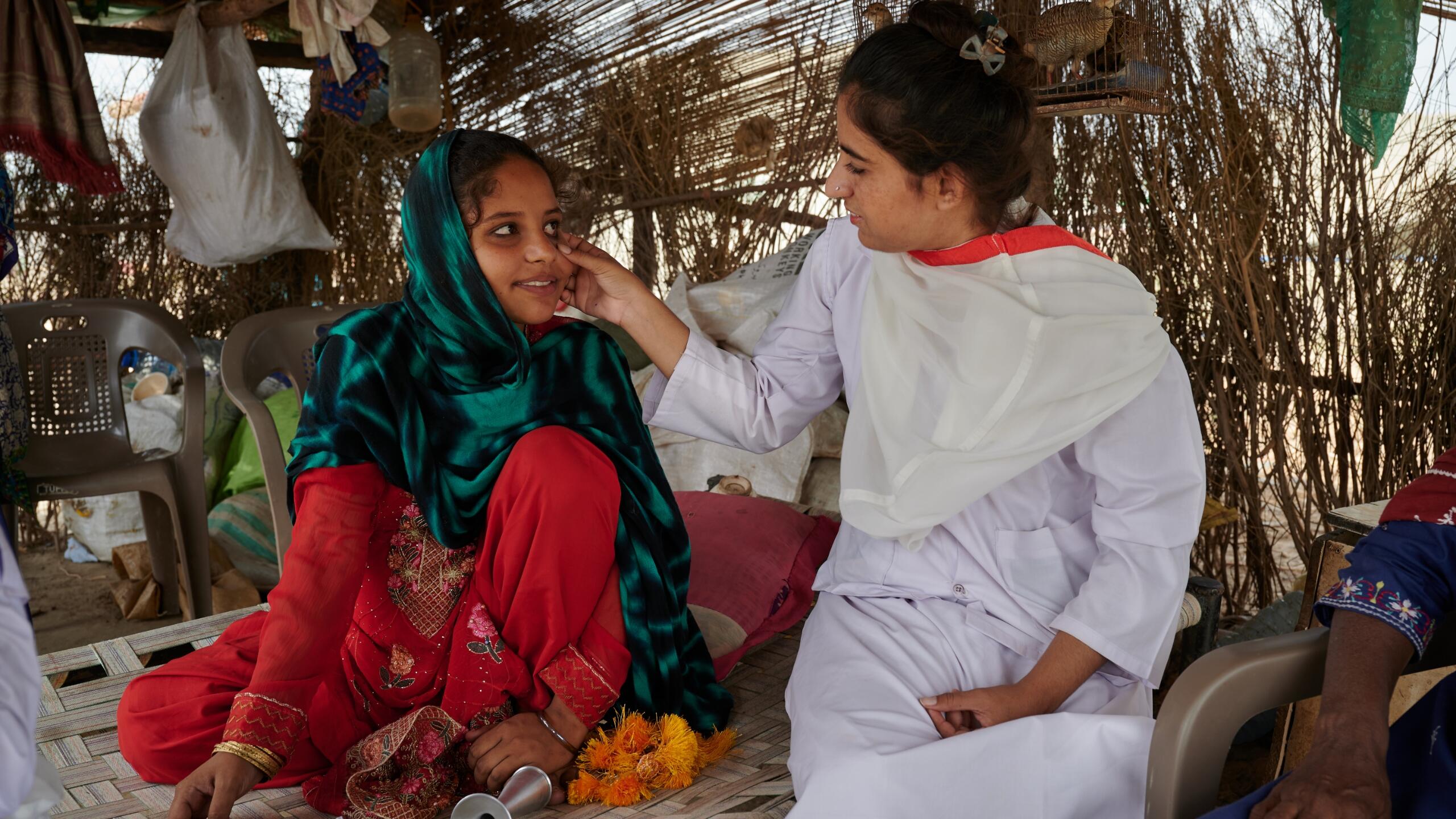 A nurse tends to a pregnant woman.